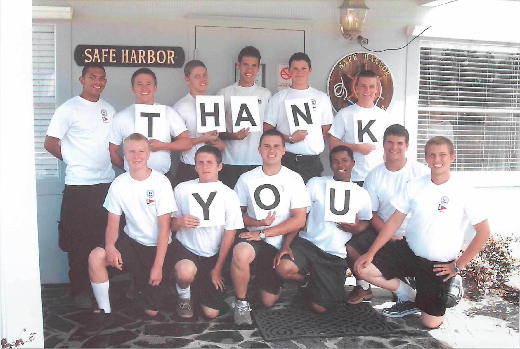 A Group Of Young Men Holding Up Signs
